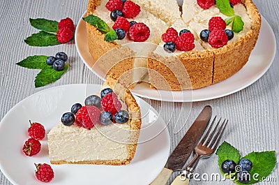 Slice of cheesecake with fresh berries on the white plate - healthy organic summer dessert. Classic New York cheesecake Stock Photo