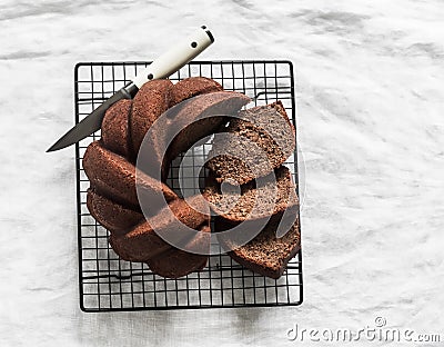 Slice of classic chocolate pound cake on a baking rack on a white background, top view Stock Photo