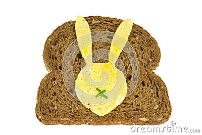 Slice of dark bread with fried egg in Easter Bunny form on it Stock Photo