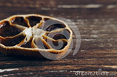 Slice of dried orange on a textural wooden table Stock Photo
