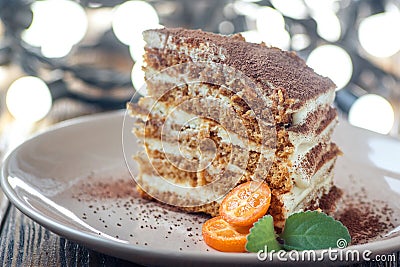 Slice of homemade layered honey cake with mint, kumquat and walnuts, traditional food of Jewish New Near. Sweet food Stock Photo