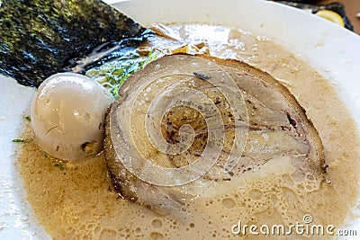 Slice of Japanese Char Siu roast pork on top of Ramen Noodle broth Stock Photo