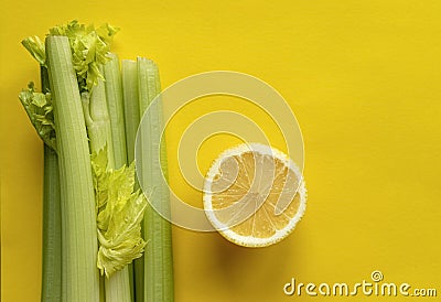 A slice of lemon and a bunch of celery Stock Photo