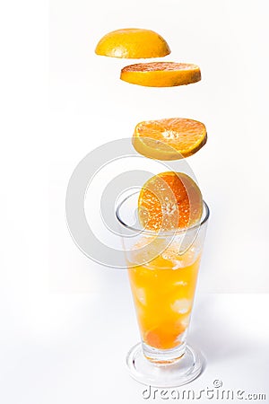 Slice oranges, put in a clear glass with fresh orange juice Stock Photo