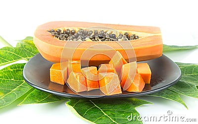 Slice papaya fruit on green leaf Stock Photo