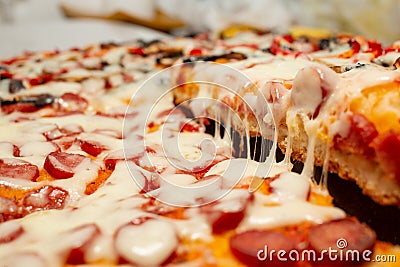 slice of pizza with a strech of melted cheese, soft focus close up Stock Photo