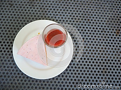 Slice of plain cheesecake with cranberry sauce on white plate decorated Stock Photo