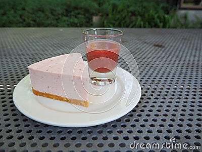 Slice of plain cheesecake with cranberry sauce on white plate decorated Stock Photo