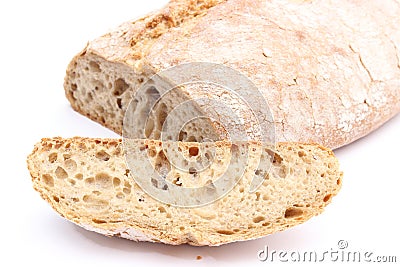 Slice of rye bread and loaf in background Stock Photo