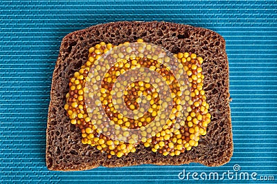 Slice of rye bread with wholegrain mustard Stock Photo