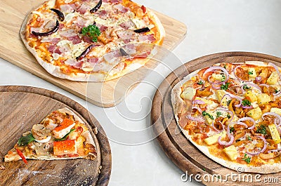 Slice of Seafood Italian Pizza and Hawaiian Chicken BBQ Italian Pizza and Bacon,Garlic and Chilli Italian Pizza on wood dish Stock Photo