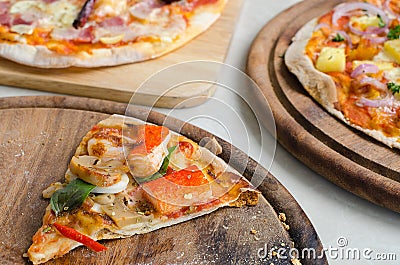 Slice of Seafood Italian Pizza and Hawaiian Chicken BBQ Italian Pizza and Bacon,Garlic and Chilli Italian Pizza on wood dish Stock Photo