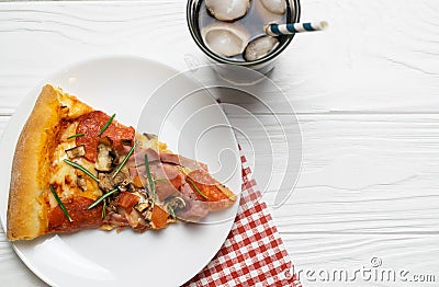 Slice of tasty pizza with pepperoni, tomatoes, cheese and soda ice drink Stock Photo