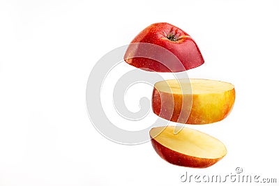 Sliced apple floating on white background. Fruit slice falling on bright backdrop Stock Photo