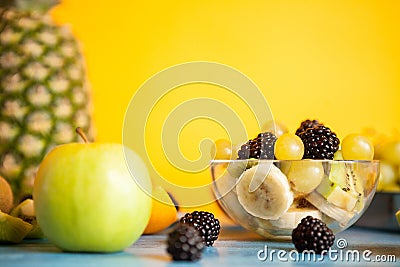 Sliced banana, grapes, kiwi and berry in a bowl Stock Photo