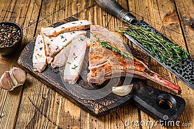 Sliced bbq rib pork chop meat steak. Wooden background. Top view Stock Photo