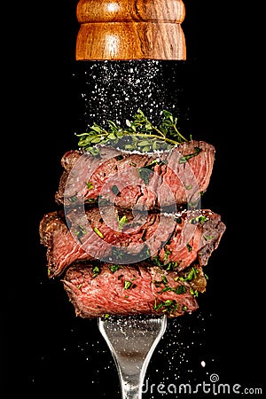 Sliced beef steak from grill on a fork Stock Photo