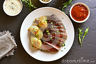 Sliced medium rare roast beef with potato Stock Photo