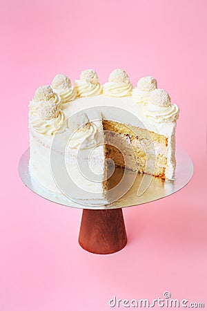 Sliced Birthday cake on the wooden cake stand. Beautiful sponge cake on the paper background. Copy space. Food photography for Stock Photo