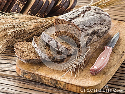 Sliced black bread on the wooden plank. Stock Photo
