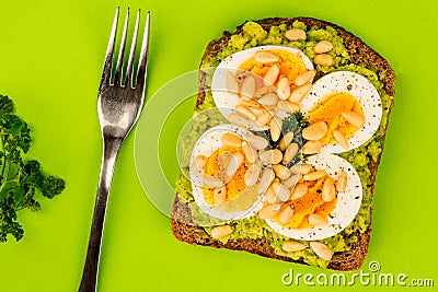 Boiled Egg on Crushed Avocado With Pine Nuts And Rye Bread Open Stock Photo
