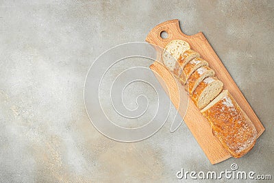 Sliced bread Ciabatta on a wooden board. kitchen or bakery. banner, menu, recipe place for text, top view Stock Photo