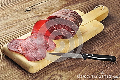 Sliced bresaola on a cutting board Stock Photo