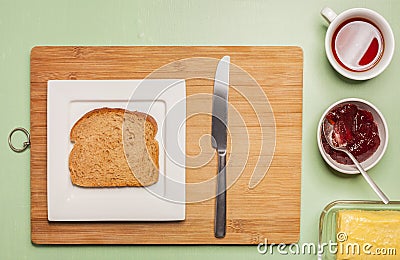 Sliced brown bread on square plate with herbal tea Stock Photo