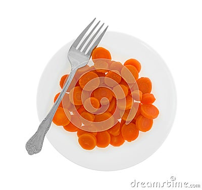 Sliced canned carrots on a white plate with a fork Stock Photo