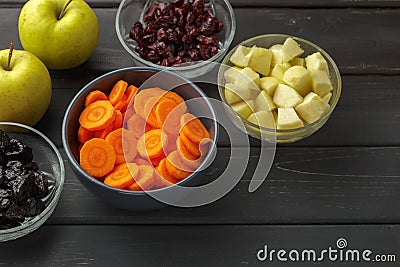 Sliced carrot, apples, dried prunes and cranberry Stock Photo