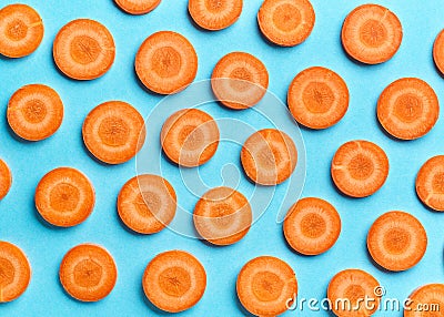 Sliced carrot on blue background Stock Photo