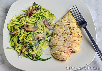 sliced chicken breast with zucchini noodles and mushrooms Stock Photo