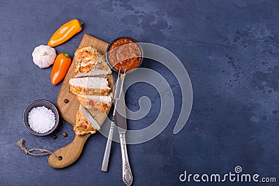 Sliced cooked chicken and cutlery Stock Photo