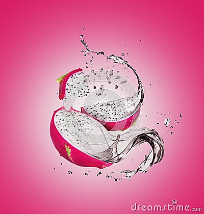 Sliced dragon fruit with splashes of juice on a pink background Stock Photo