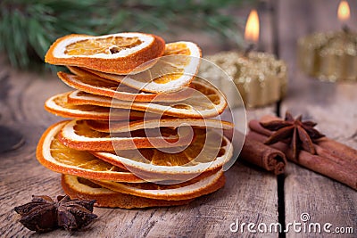 Sliced of dried orange, cinnamon sticks, anise stars and candle with pine brunch Stock Photo