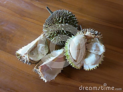 Sliced durian on the table. Hard and sharp spines. Tasty and sweet fruit. Stock Photo