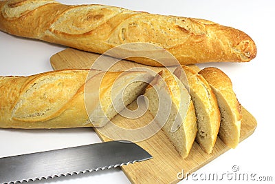 Sliced fresh baguette and bread knife Stock Photo