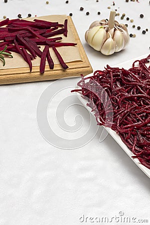 Sliced fresh beets on a cutting board. Garlic. Sliced fermented beets Stock Photo