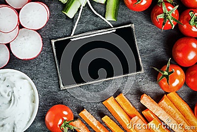 Sliced fresh vegetable frame around a slate Stock Photo