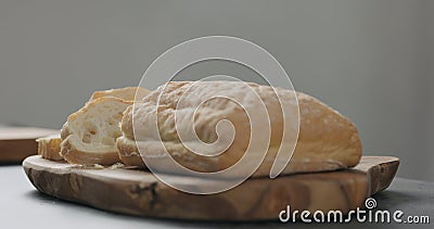 Sliced freshly bakled ciabatta bread on olive board Stock Photo