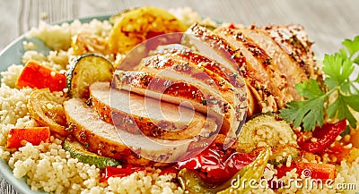 Sliced grilled chicken breasts on couscous Stock Photo