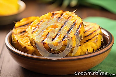 sliced grilled pineapple in a fruit bowl Stock Photo