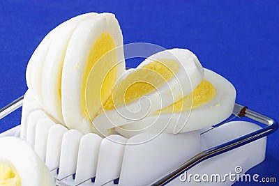 Sliced hard-boiled egg in egg slicer Stock Photo