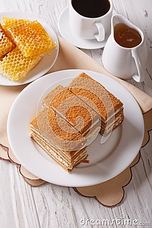 Sliced honey cake close-up and coffee. vertical Stock Photo