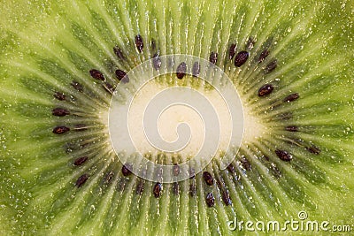 A sliced kiwifruit and spoon with a piece of kiwifruit Stock Photo