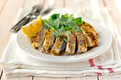 Sliced lemon herb crusted chicken breast Stock Photo