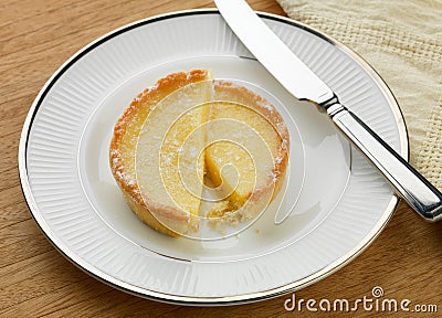 Sliced lemon tart and knife Stock Photo