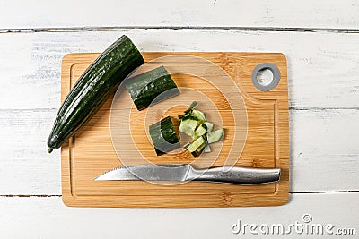 Sliced long cucumber on a bamboo wooden board Stock Photo