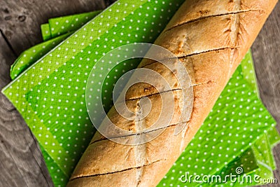 Sliced long french bread over wooden table. Baguette. Restaurant Stock Photo