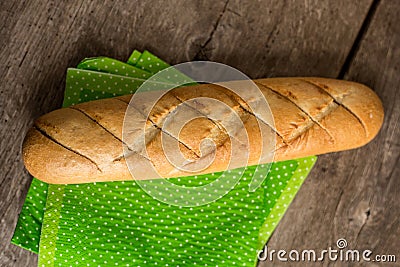 Sliced long french bread over wooden table. Baguette. Restaurant Stock Photo